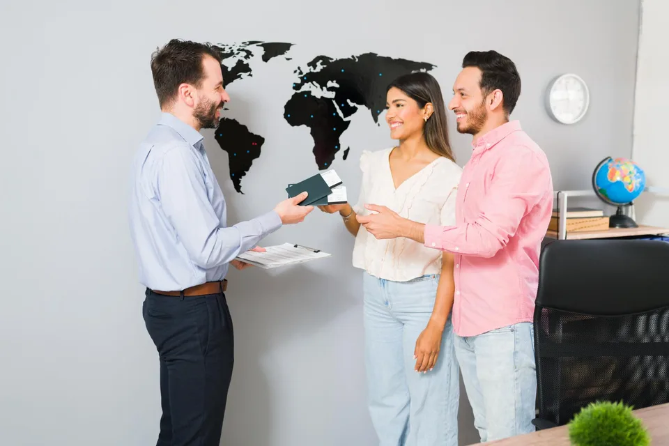 A couple discussing their travel documents with an adviser